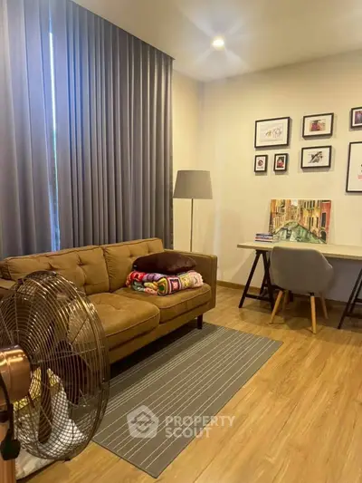 Cozy living room with modern decor, featuring a comfortable sofa, stylish desk, and elegant floor lamp.