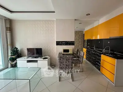 Modern open-layout kitchen and living area with sleek design and vibrant colors.
