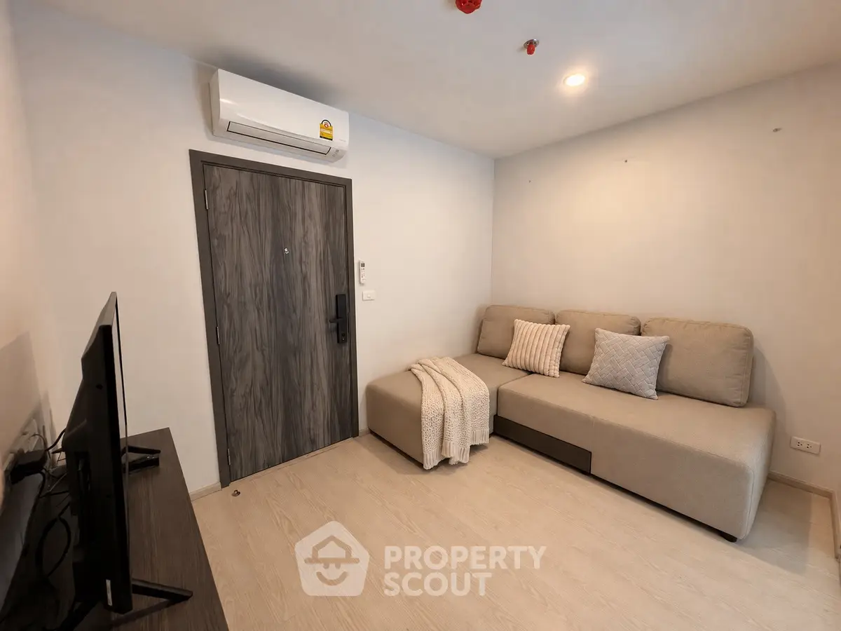 Modern living room with cozy sofa and air conditioning in a stylish apartment.