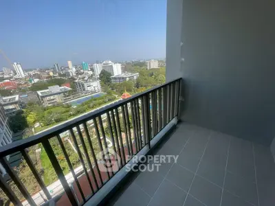 Spacious balcony with stunning city view in modern high-rise apartment