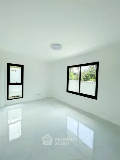 Bright empty room with large windows and glossy white floor tiles