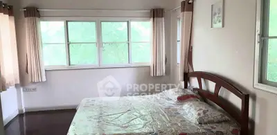 Spacious bedroom with large windows and natural light