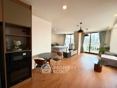 Spacious modern living room with city view, open layout, and stylish furnishings.