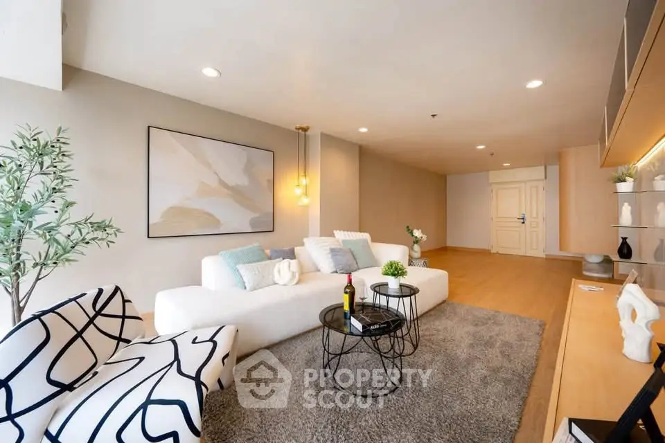 Spacious modern living room with stylish decor and cozy seating area.