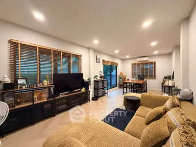 Spacious living room with modern decor and large windows for natural light