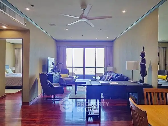 Spacious living room with modern decor and large windows offering natural light.