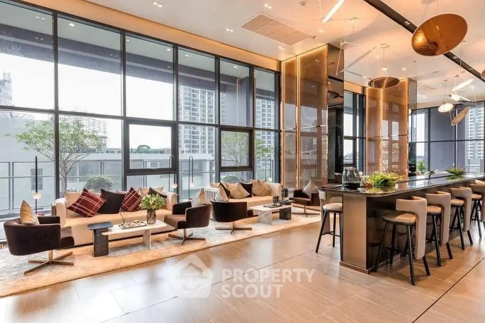 Luxurious modern living room with floor-to-ceiling windows and stylish decor in high-rise building.