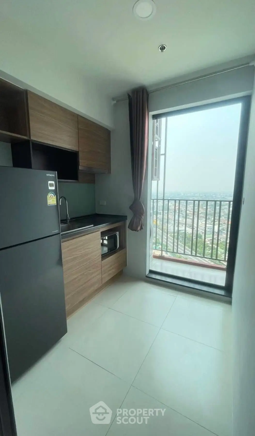 Modern kitchen with balcony view in high-rise apartment
