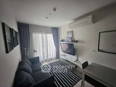 Modern living room with sleek furniture and wall-mounted TV, featuring a cozy atmosphere.