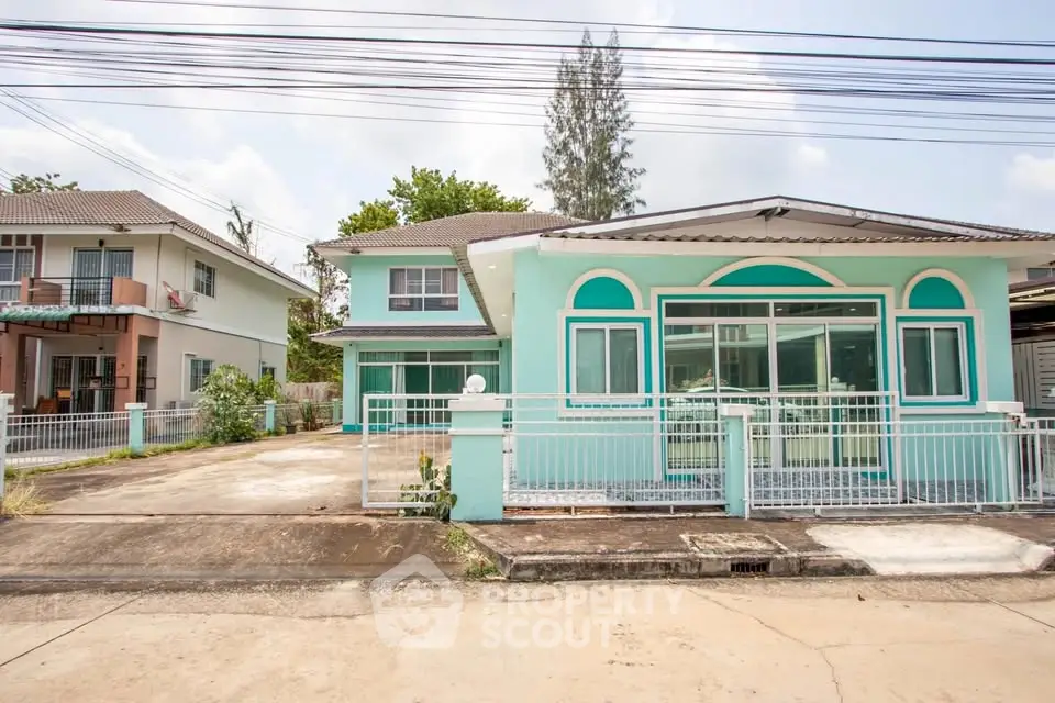 Charming two-story house with vibrant exterior and spacious driveway