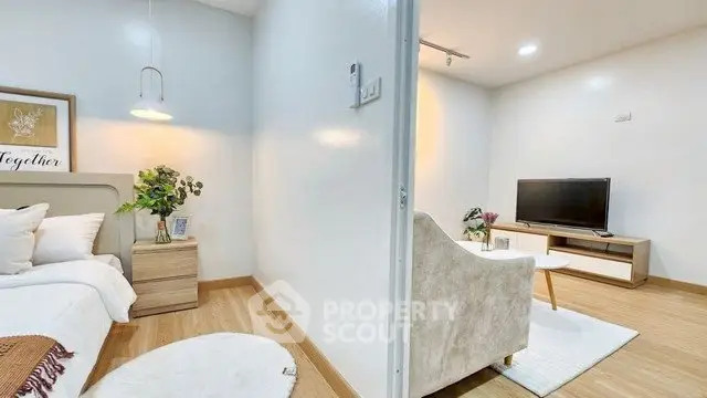 Modern open-plan living room and bedroom with stylish decor and cozy ambiance.