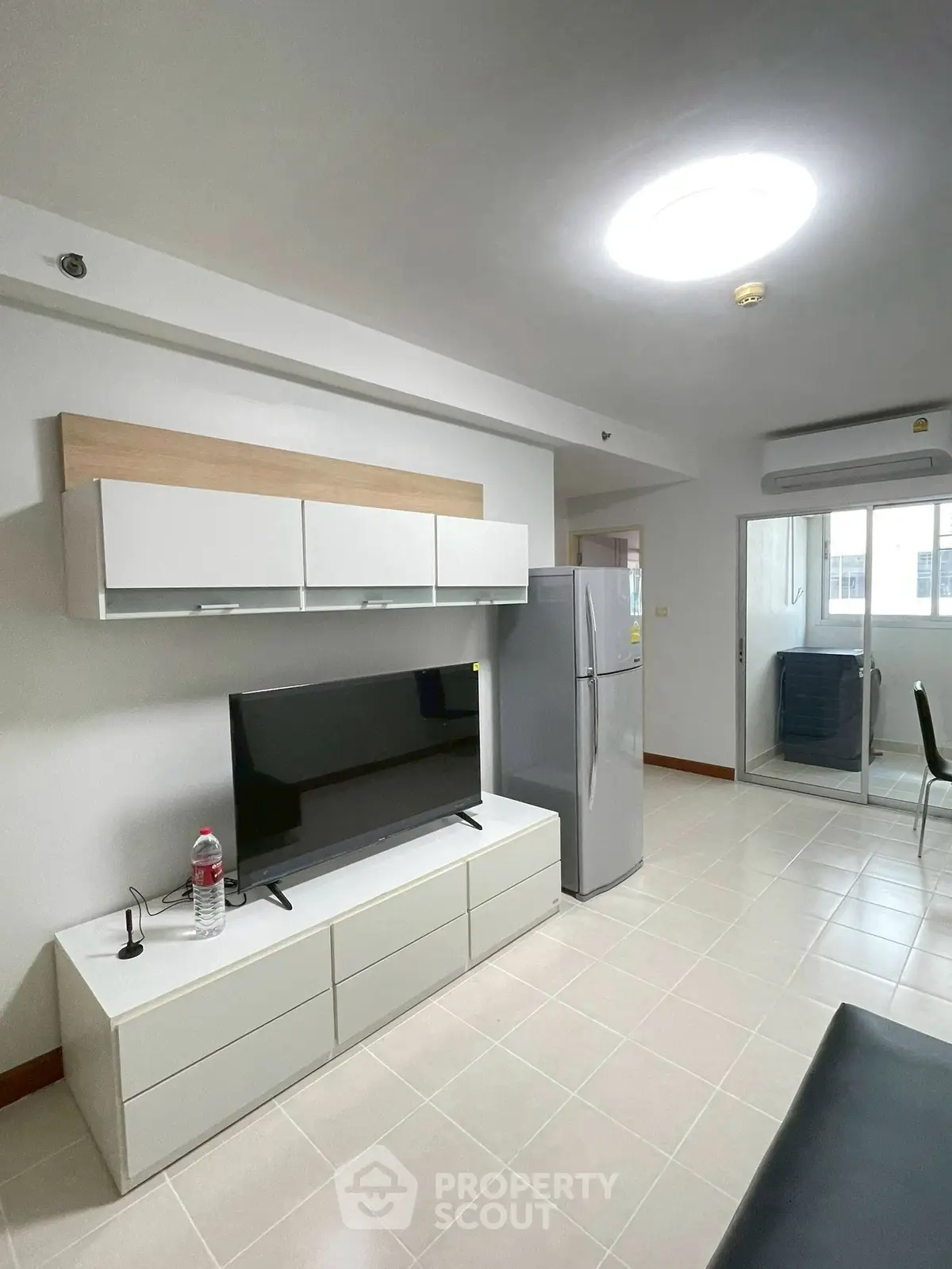 Modern living room with sleek TV setup and spacious layout in a contemporary apartment.