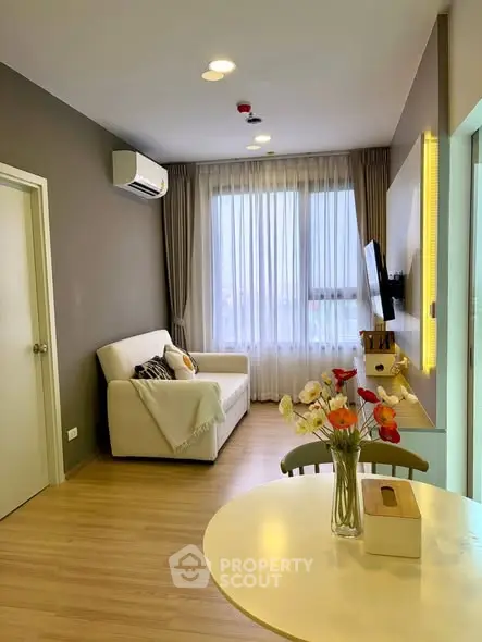 Modern living room with cozy sofa and stylish decor in a bright apartment.