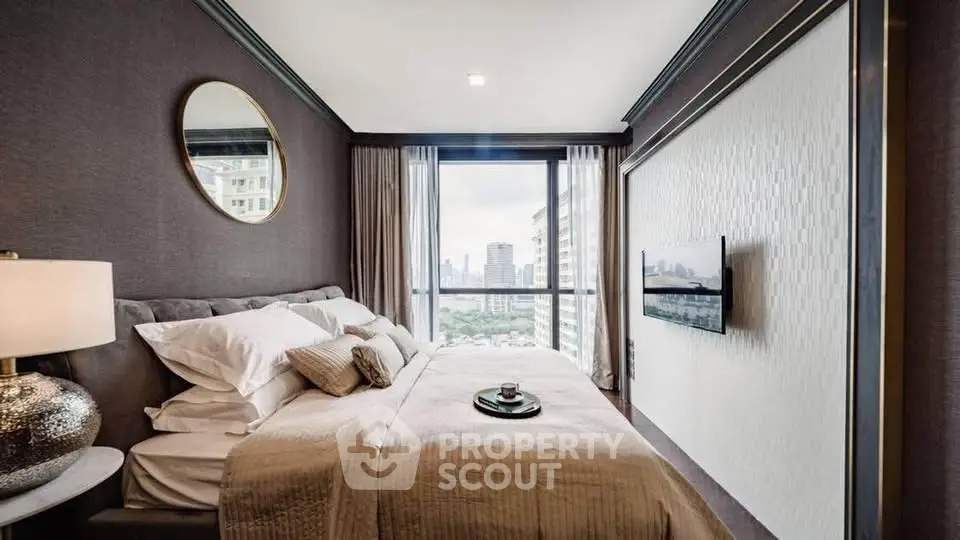 Luxurious bedroom with city view, elegant decor, and modern amenities in high-rise apartment.