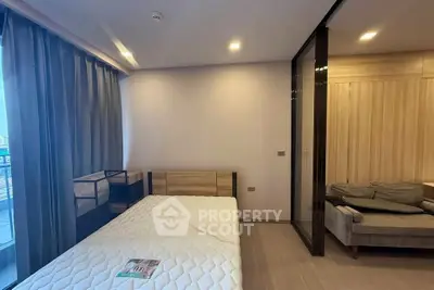 Modern bedroom with cozy bed and stylish decor in a contemporary apartment.