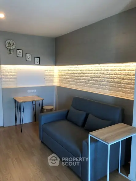 Modern living room with stylish sofa and accent lighting