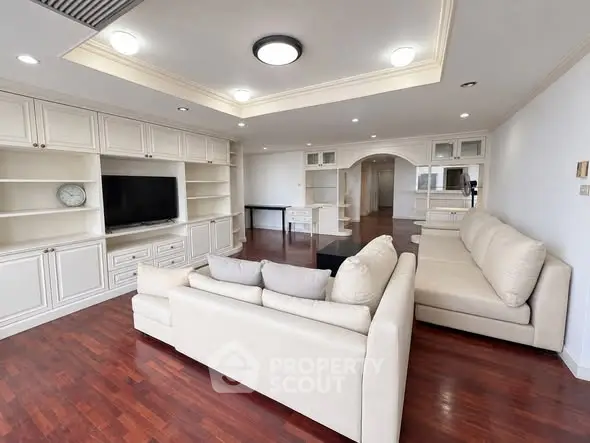 Spacious living room with elegant built-in shelving and cozy seating area.