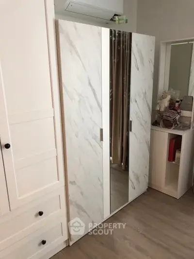 Stylish bedroom with modern wardrobe and elegant decor