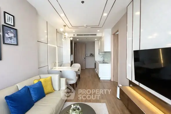 Modern living room with elegant decor and open kitchen layout