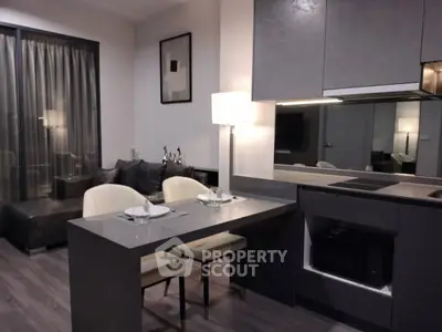 Modern open-plan kitchen and living area with sleek design and cozy seating.