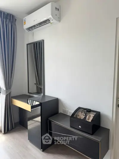 Modern bedroom with sleek furniture and air conditioning unit