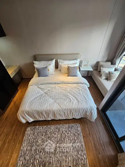 Luxurious bedroom with elegant decor and cozy seating area, perfect for relaxation and comfort.