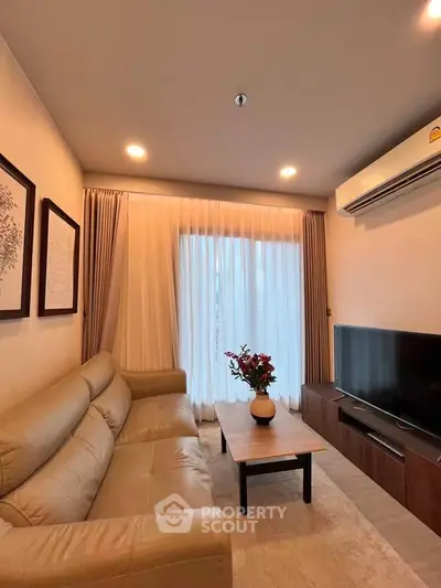 Cozy living room with modern decor, featuring a comfortable sofa, flat-screen TV, and elegant curtains.