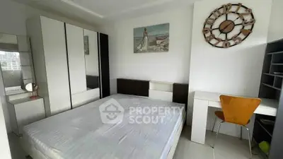 Modern bedroom with stylish decor and ample storage in a contemporary apartment.