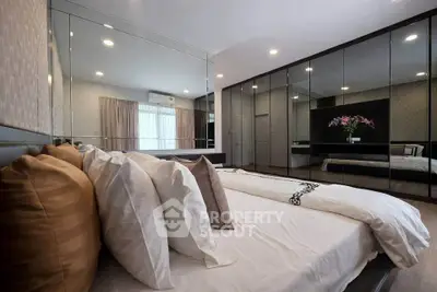 Luxurious bedroom with mirrored wardrobe and elegant decor