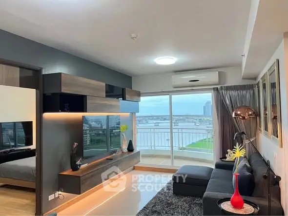 Modern living room with stylish decor and stunning river view from balcony.