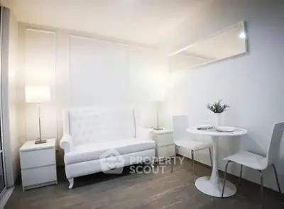 Elegant modern living room with white sofa and dining set, perfect for stylish urban living.