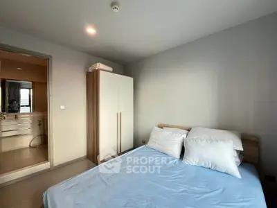 Modern bedroom with minimalist design and ensuite bathroom in a stylish apartment.