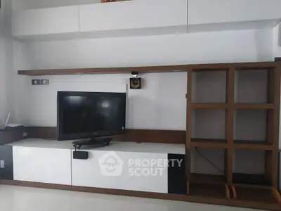 Modern living room with sleek TV unit and open shelving