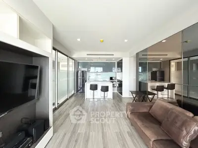 Modern open-plan living room with sleek kitchen and stylish decor