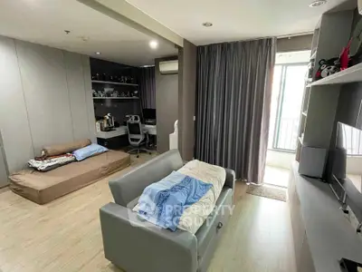 Spacious living room with modern decor and balcony access, perfect for relaxation and entertainment.