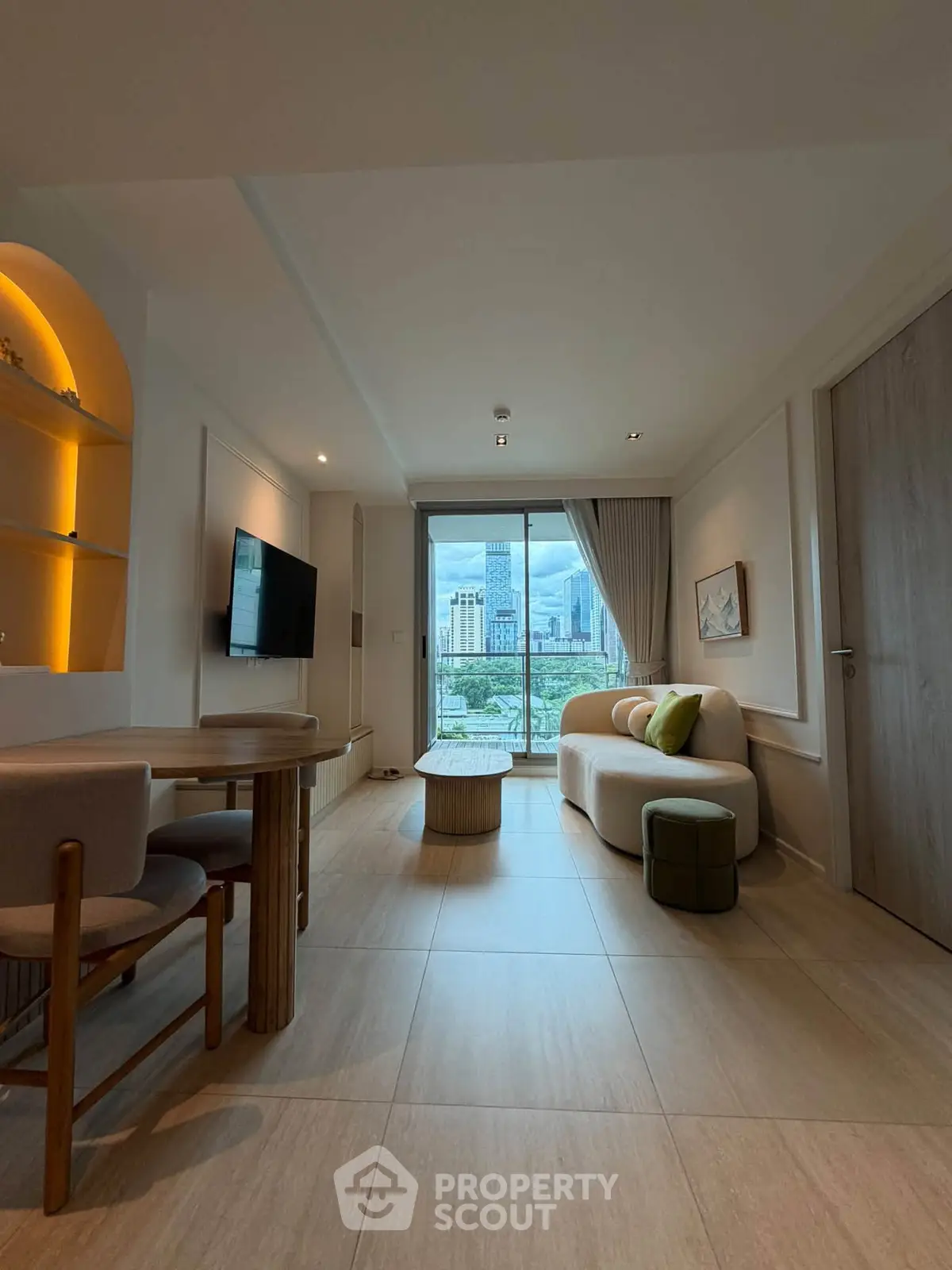 Modern living room with city view, featuring elegant furniture and stylish decor.