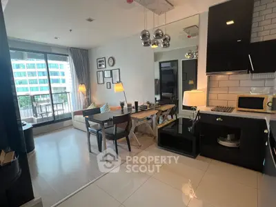Modern open-plan living and dining area with balcony view in a stylish apartment.