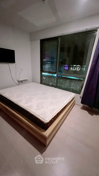 Modern bedroom with large window and minimalist decor