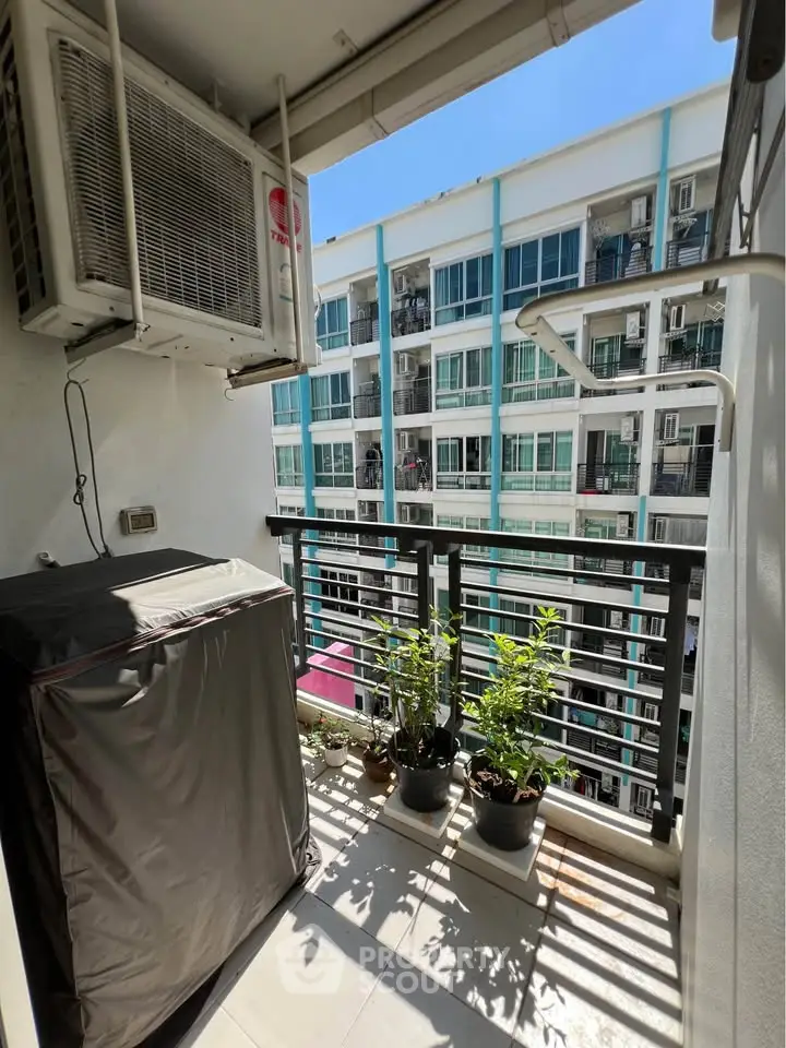 Charming balcony with potted plants and city view, perfect for relaxation.