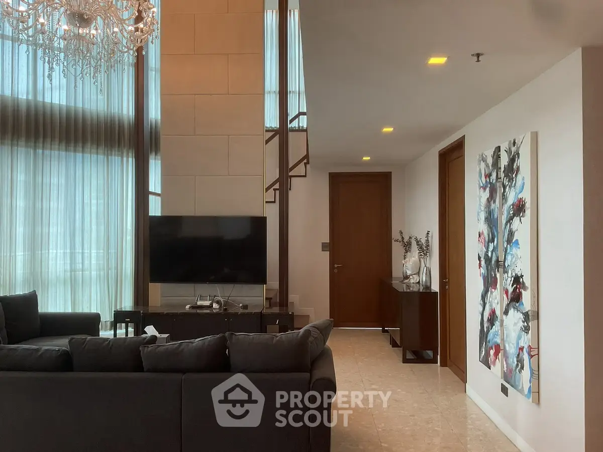 Luxurious living room with high ceilings and elegant chandelier