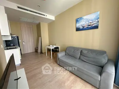 Modern living room with cozy sofa and dining area in a compact apartment