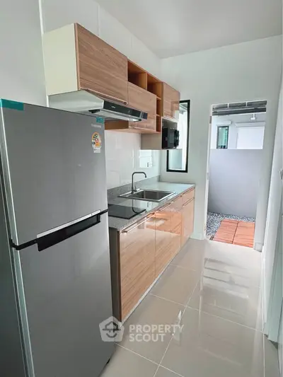 Modern kitchen with sleek cabinetry and stainless steel fridge