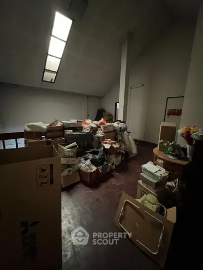 Spacious storage room with various boxes and items, ideal for organizing and decluttering.