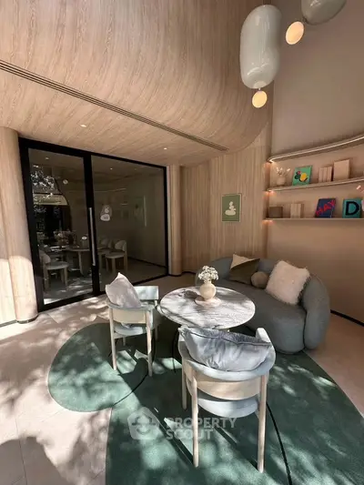 Modern living room with stylish furniture and natural light, featuring a cozy seating area and elegant decor.