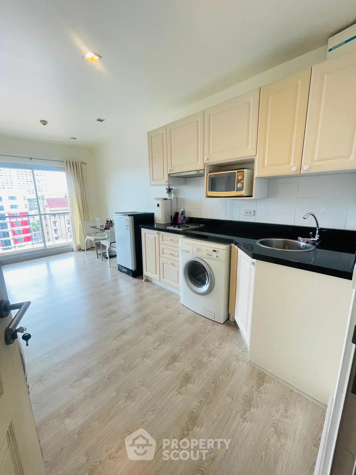 Spacious kitchen with modern appliances and natural light in a stylish apartment.