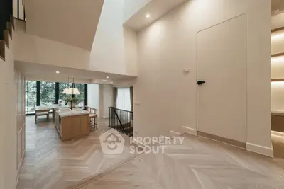 Elegant open-plan living and dining area with natural light and modern design.
