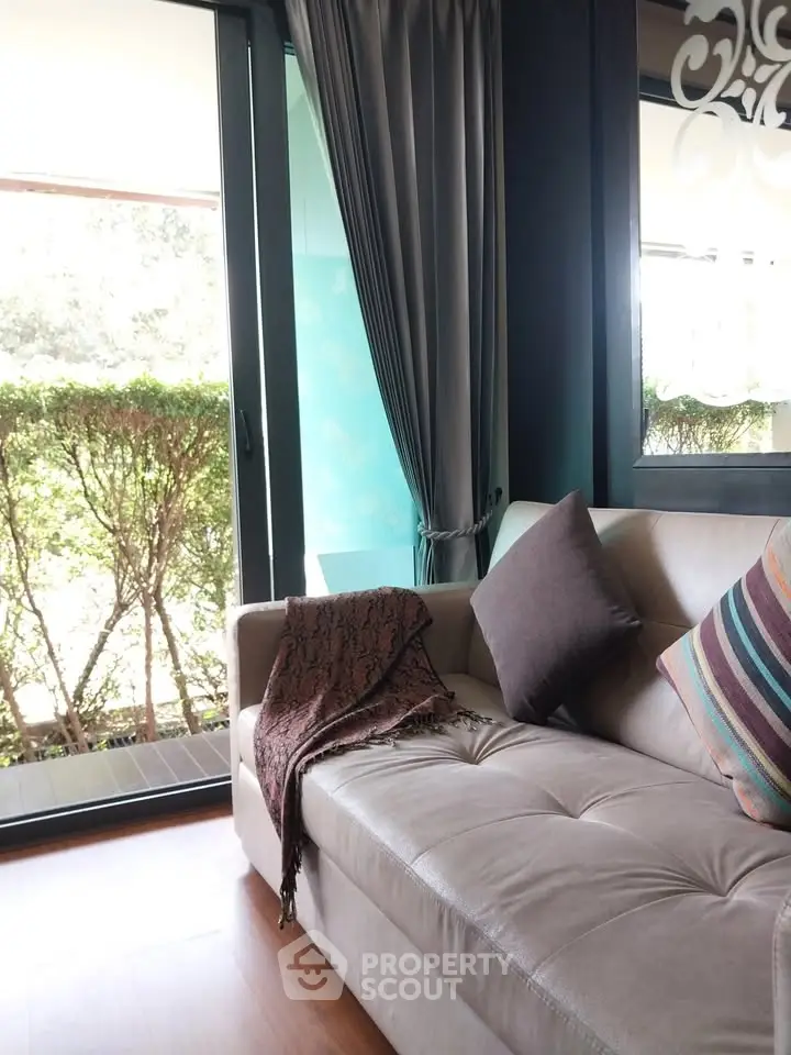 Stylish living room with cozy sofa and garden view, perfect for relaxation.