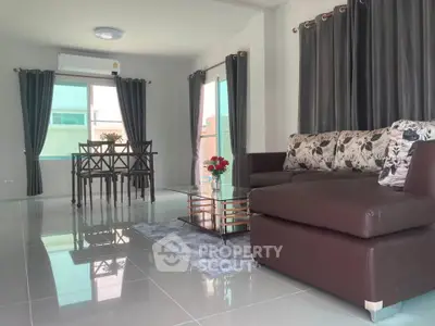 Spacious living room with modern furniture and elegant decor, perfect for relaxation and entertaining.