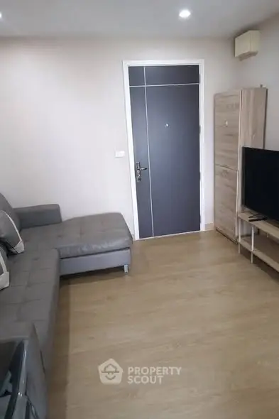 Modern living room with sleek furniture and wooden flooring