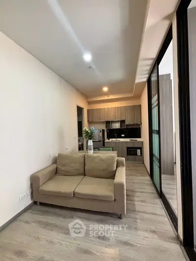 Modern living room with cozy sofa and open kitchen layout in stylish apartment